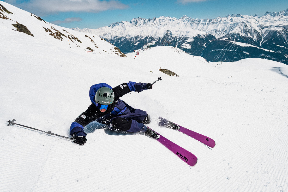 Skier carving a groomed run on Faction Dancer skis