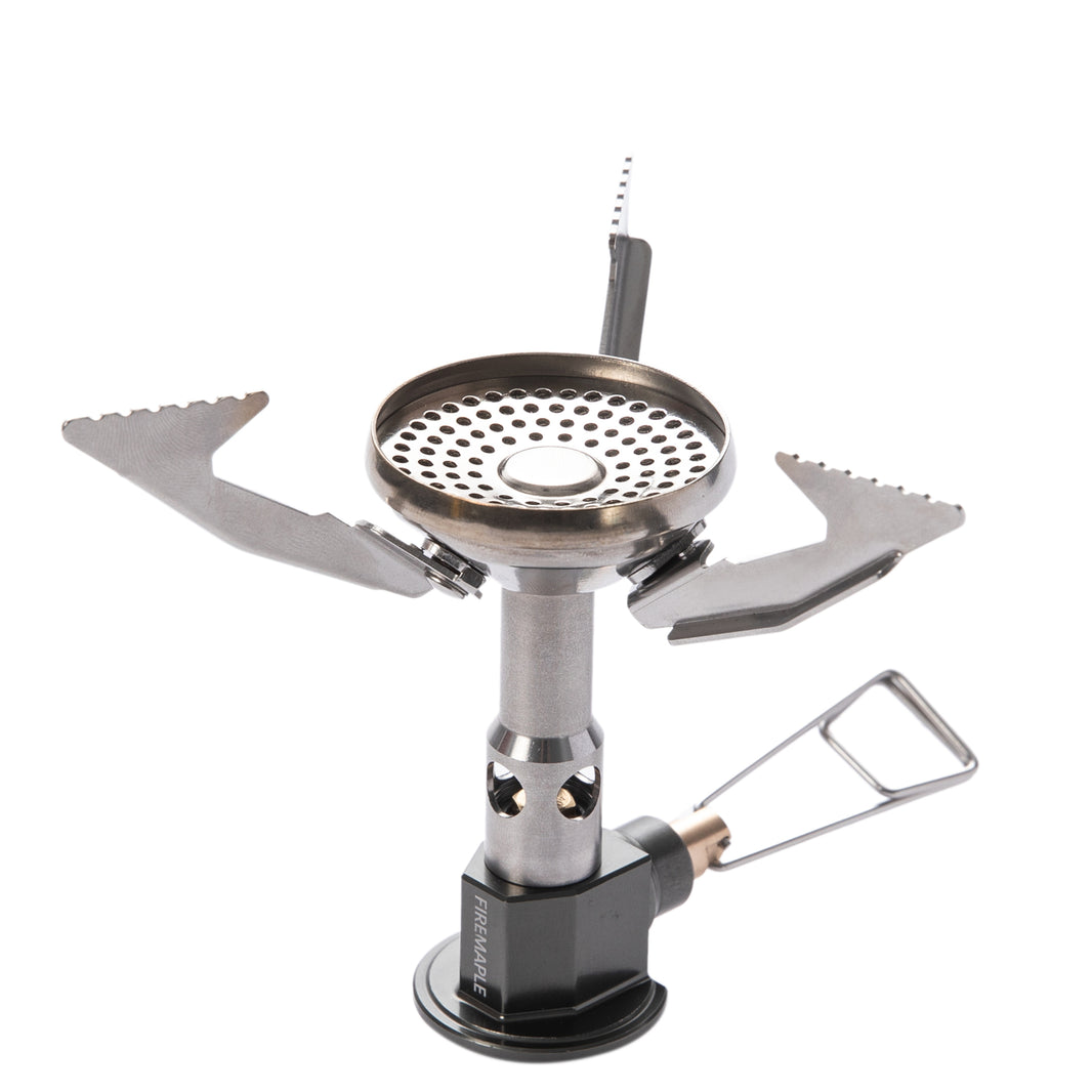 A portable camping gas stove with foldable metal arms and a pressure regulator.
