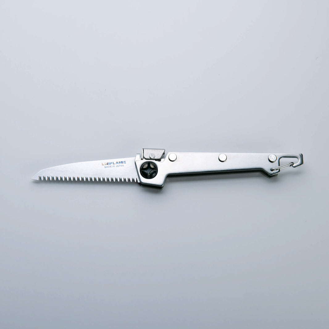 A folding saw with a stainless steel handle and a serrated blade, finished with Tsubamesanjo.