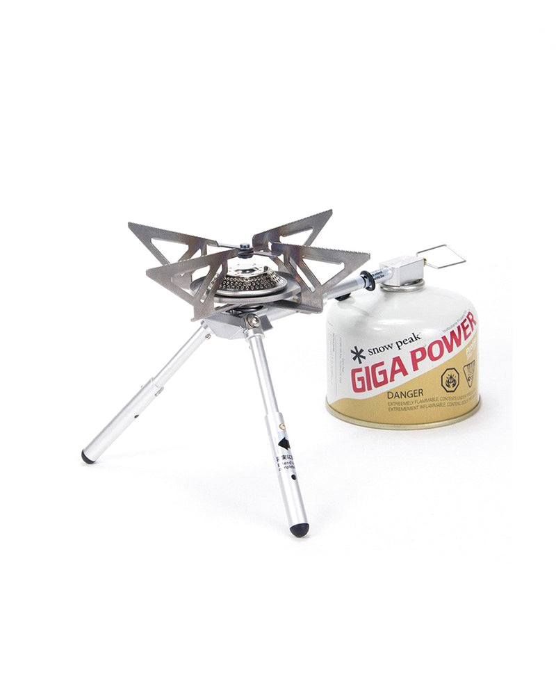 Snow Peak BiPod Stove GS-370 on two folding legs, pot arms open, GigaPower canister attached at right