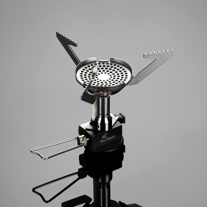 A silver portable camping stove with a windproof burner design and built-in electric ignition.