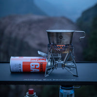 Campingmoon XD‑3 butane stove set up with pot on burner and canister attached, wilderness backdrop
