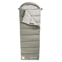 A green rectangular Naturehike sleeping bag with a hood, made of cotton, displayed in an upright position.