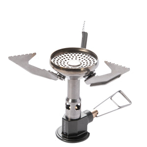 A portable camping gas stove with foldable metal arms and a pressure regulator.
