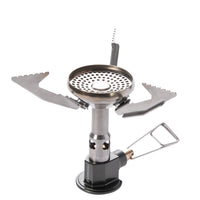A portable camping gas stove with foldable metal arms and a pressure regulator.