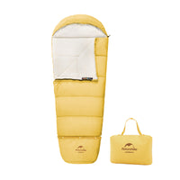 Yellow sleeping bag with carrying bag on a white background