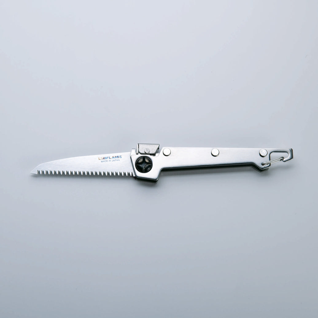 A folding saw with a stainless steel handle and a serrated blade, finished with Tsubamesanjo.