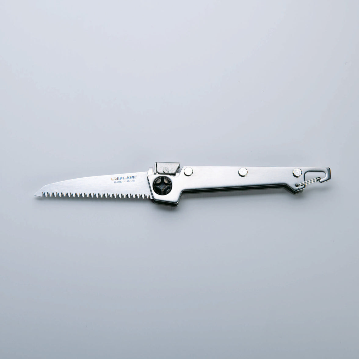 A folding saw with a stainless steel handle and a serrated blade, finished with Tsubamesanjo.