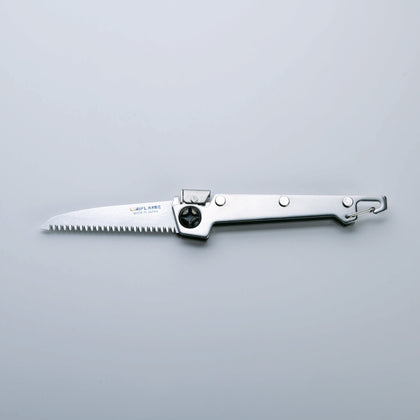 A folding saw with a stainless steel handle and a serrated blade, finished with Tsubamesanjo.