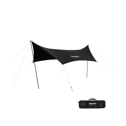 A black tarp set up outdoors with a carrying case lying in front.