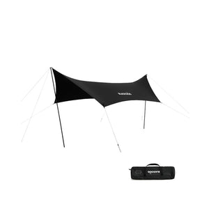 A black tarp set up outdoors with a carrying case lying in front.