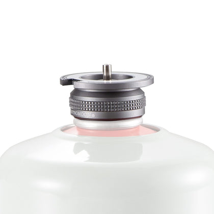 A close-up image of a silver butane stove adapter with a magnetic lock system, attached to a white cylindrical container.