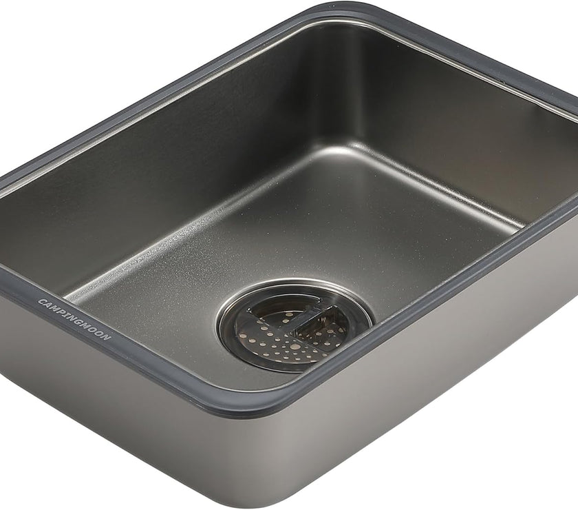 Stainless steel kitchen sink with drainboard on a white background