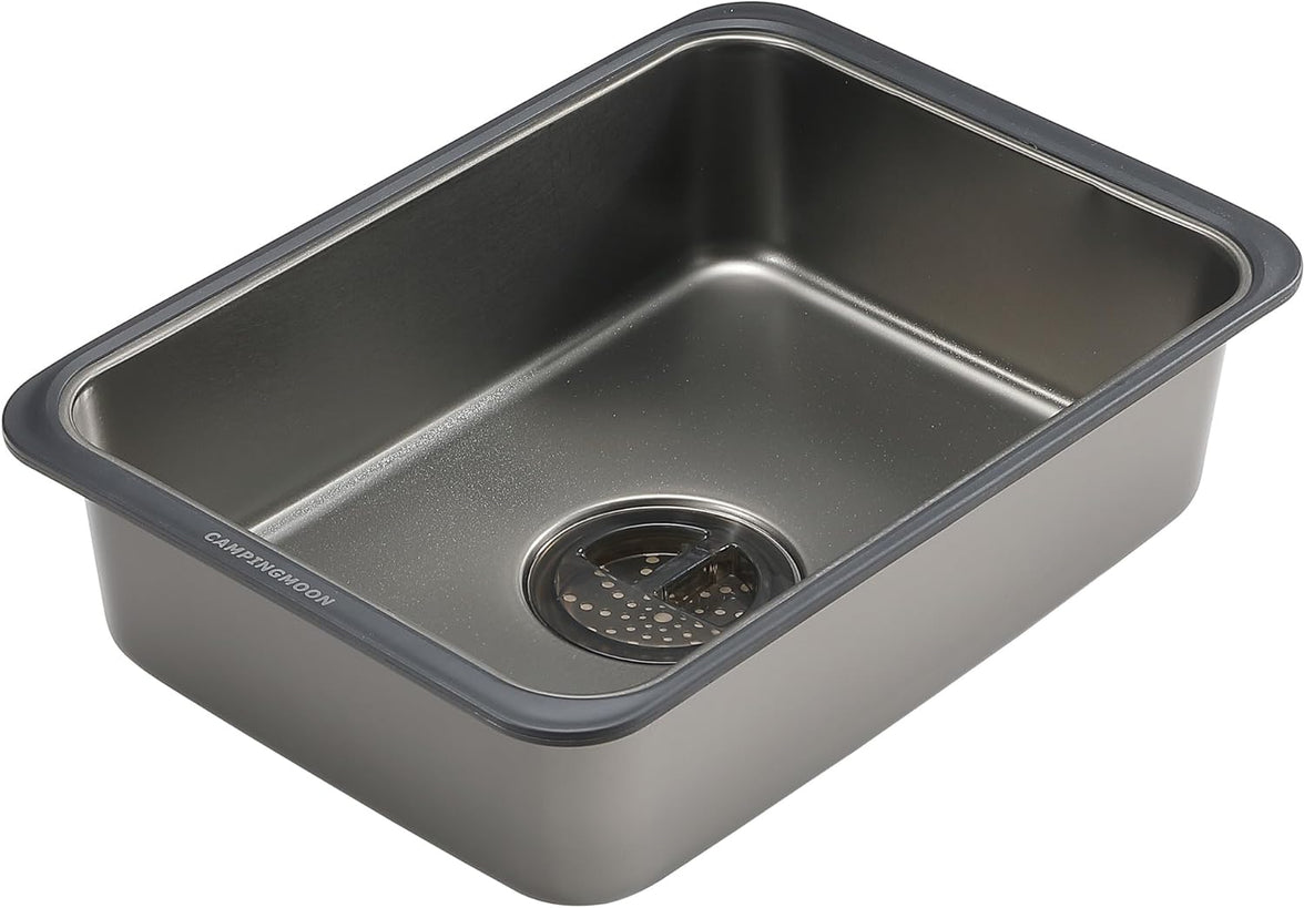 Stainless steel kitchen sink with drainboard on a white background