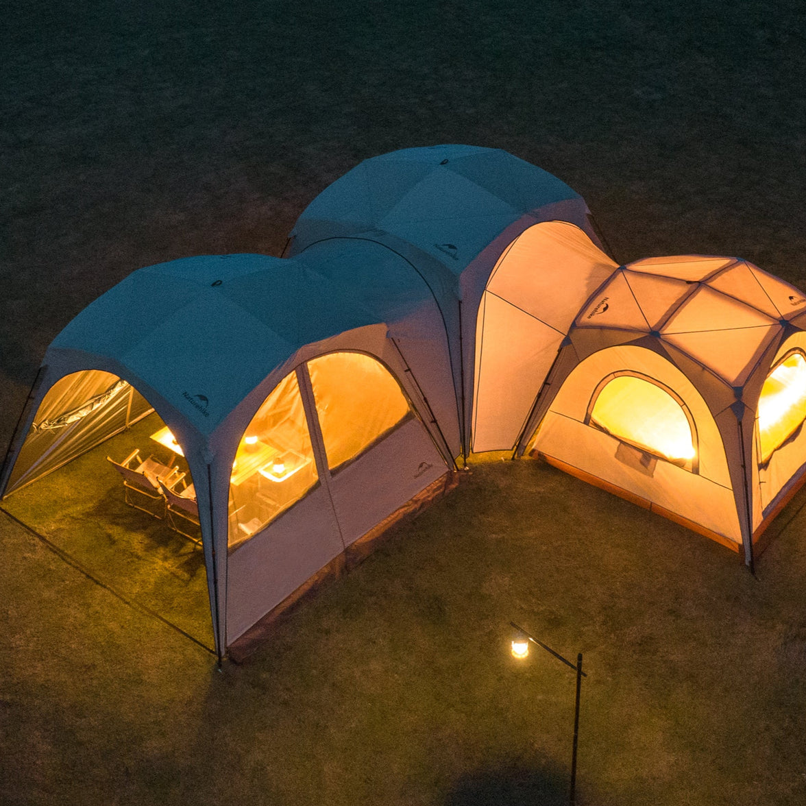 Two connected tents with warm lighting on a dark outdoor setting, labeled 'DIY Ultimated Connectivity'.