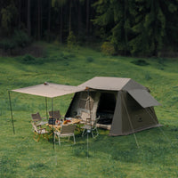 A brown Naturehike Village6.0 2 generation Quick Open Tent set up on a grassy field with an attached awning and outdoor furniture inside the tent's open entrance.