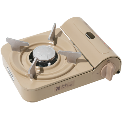 A portable gas stove in beige color with a visible brand logo on the front.