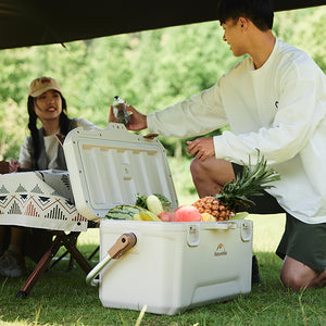 A guy give drinks to friend, all fresh fruits keep inside of Naturehike Ling Xia cooler