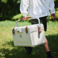 A guy holding the Naturehike Ling xia Cooler walking on the grass