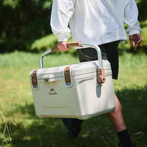 A guy holding the Naturehike Ling xia Cooler walking on the grass