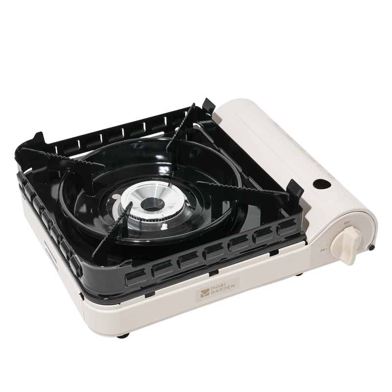 A portable gas stove with a black surface and silver and white sides.