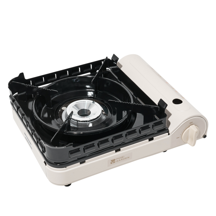 A portable gas stove with a black surface and silver and white sides.