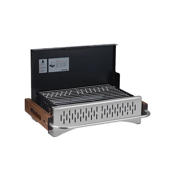 A foldable black tabletop travel BBQ grill with wooden handles and a detachable baking net.