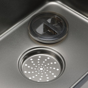 Close-up of a kitchen sink drain with a strainer cover.