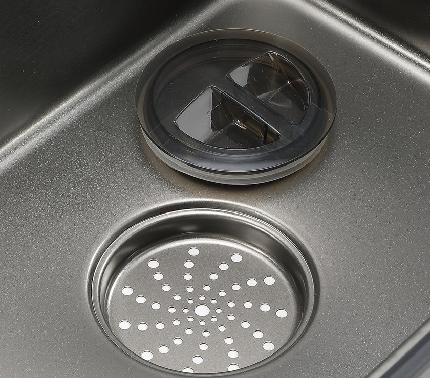 Close-up of a kitchen sink drain with a strainer cover.
