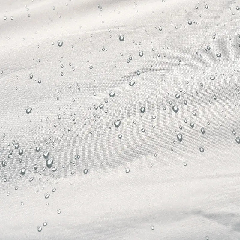 Close-up of water droplets on a textured white surface