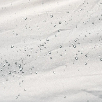 Close-up of water droplets on a textured white surface
