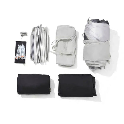 Set of camping gear including a tent, sleeping bags, and stakes on a white background