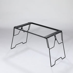 A black steel foldable camping table with a simple, sturdy design featuring four legs and a flat surface.