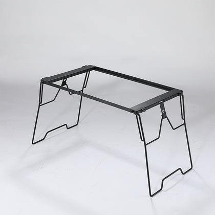 A black steel foldable camping table with a simple, sturdy design featuring four legs and a flat surface.
