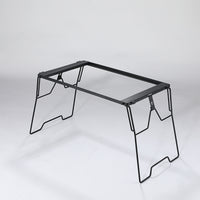 A black steel foldable camping table with a simple, sturdy design featuring four legs and a flat surface.
