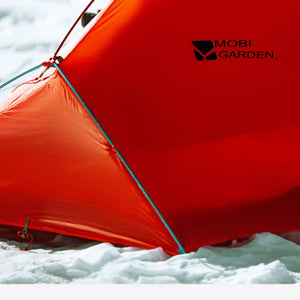 Red tent with 'Mobi Garden' logo in a snowy landscape