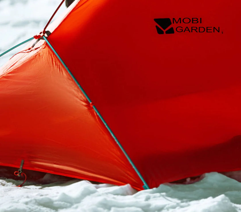 Red tent with 'Mobi Garden' logo in a snowy landscape