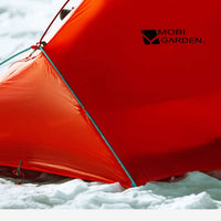 Red tent with 'Mobi Garden' logo in a snowy landscape