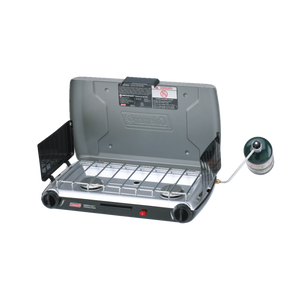 Coleman 2 Burner Triton Series Stove, open, with two burners and a windscreen.