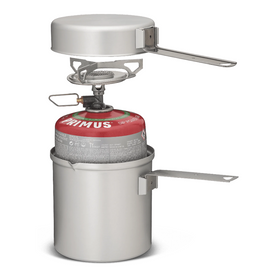 Primus Essential Trail Kit fully nested: stove, pot, lid, handles, and mesh storage bag