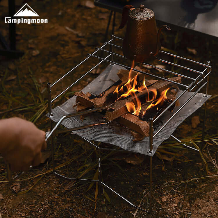 Charcoal burning inside the Solo-202 mesh fire pit, showing cooking grate in use.