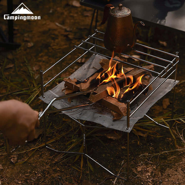Charcoal burning inside the Solo-202 mesh fire pit, showing cooking grate in use.