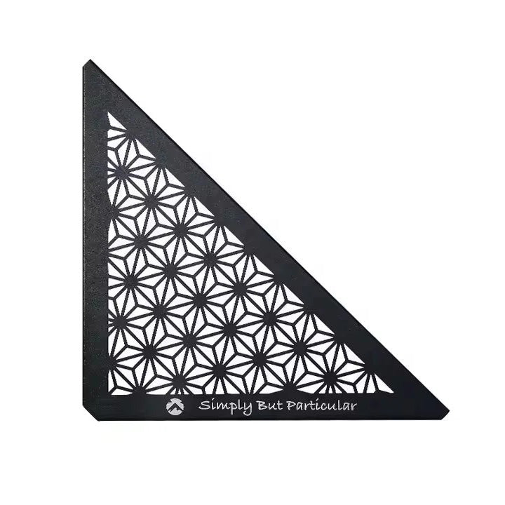 A black triangular ceiling panel with a geometric pattern, featuring the text 'Simply But Particular' on the bottom right corner.