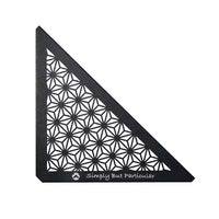 A black triangular ceiling panel with a geometric pattern, featuring the text 'Simply But Particular' on the bottom right corner.