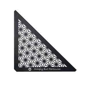 A black triangular ceiling panel with a geometric pattern, featuring the text 'Simply But Particular' on the bottom right corner.