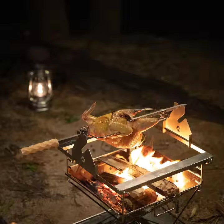 Outdoor setup of MK‑60 rotisserie skewering chicken with hand crank on stainless steel rod