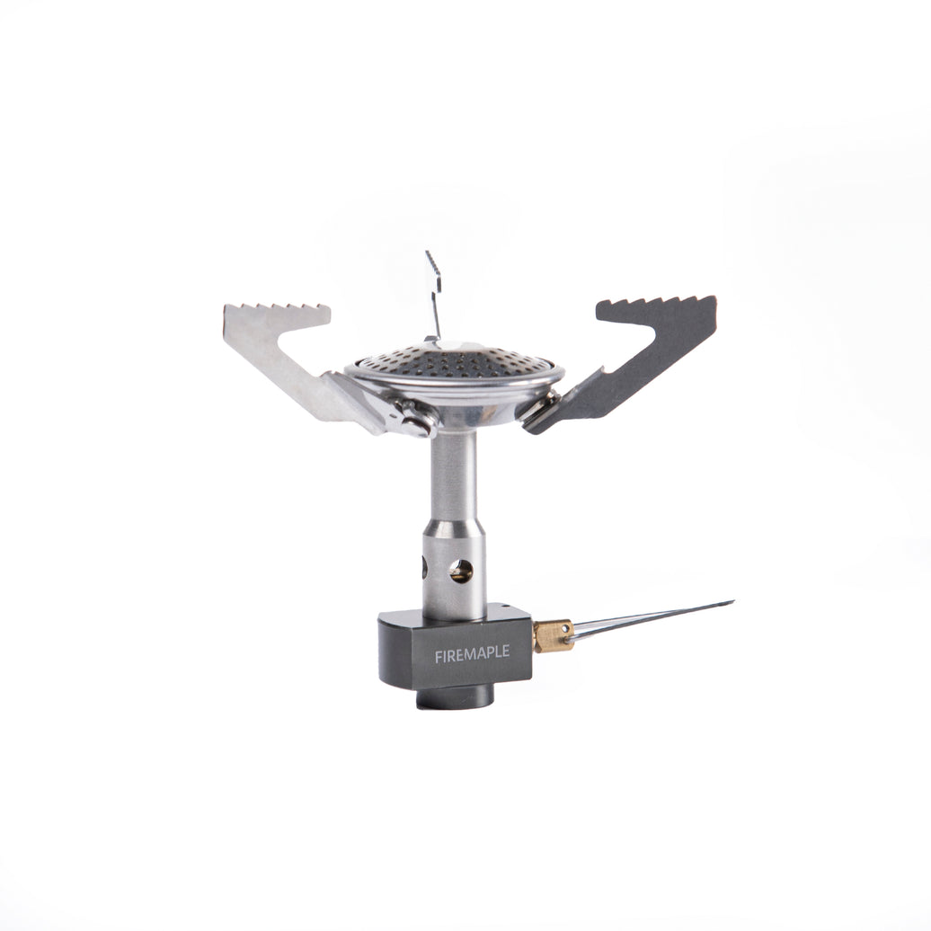 A Fire Maple Buzz Gas Stove with a silver finish, featuring a foldable design and a wind guard.