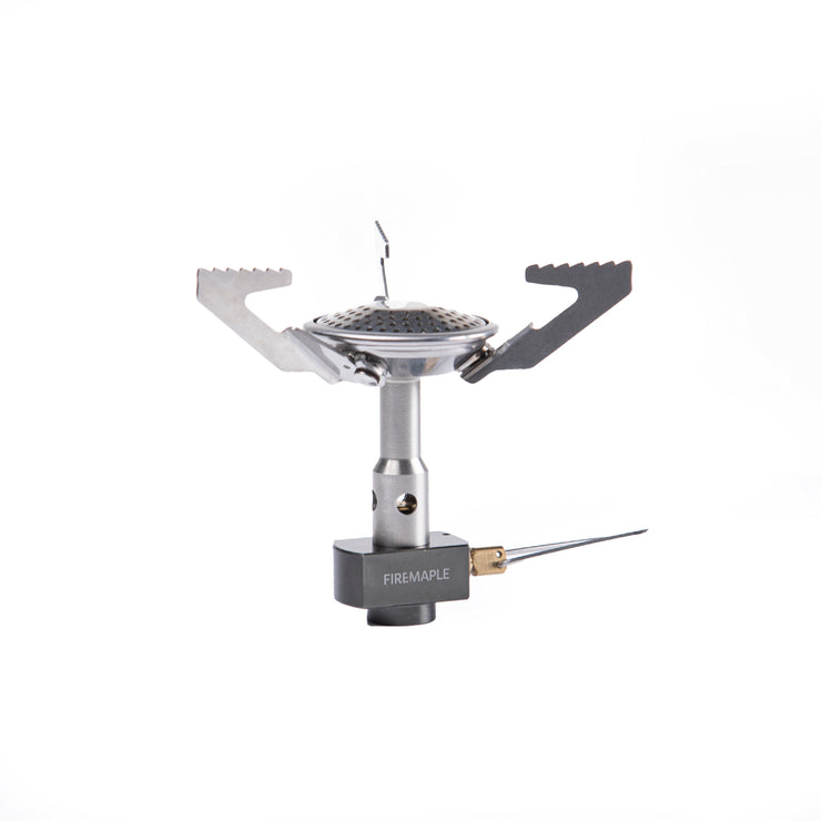 A Fire Maple Buzz Gas Stove with a silver finish, featuring a foldable design and a wind guard.