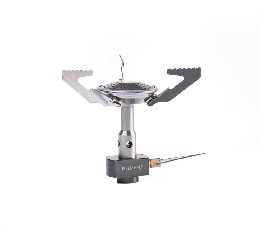 A Fire Maple Buzz Gas Stove with a silver finish, featuring a foldable design and a wind guard.