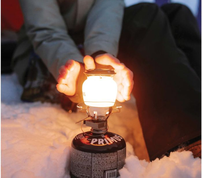 Close-up of Primus EasyLight components with protective plastic case beside it